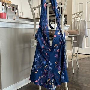 Short/romper sits high at waist with straps that tie around waist.